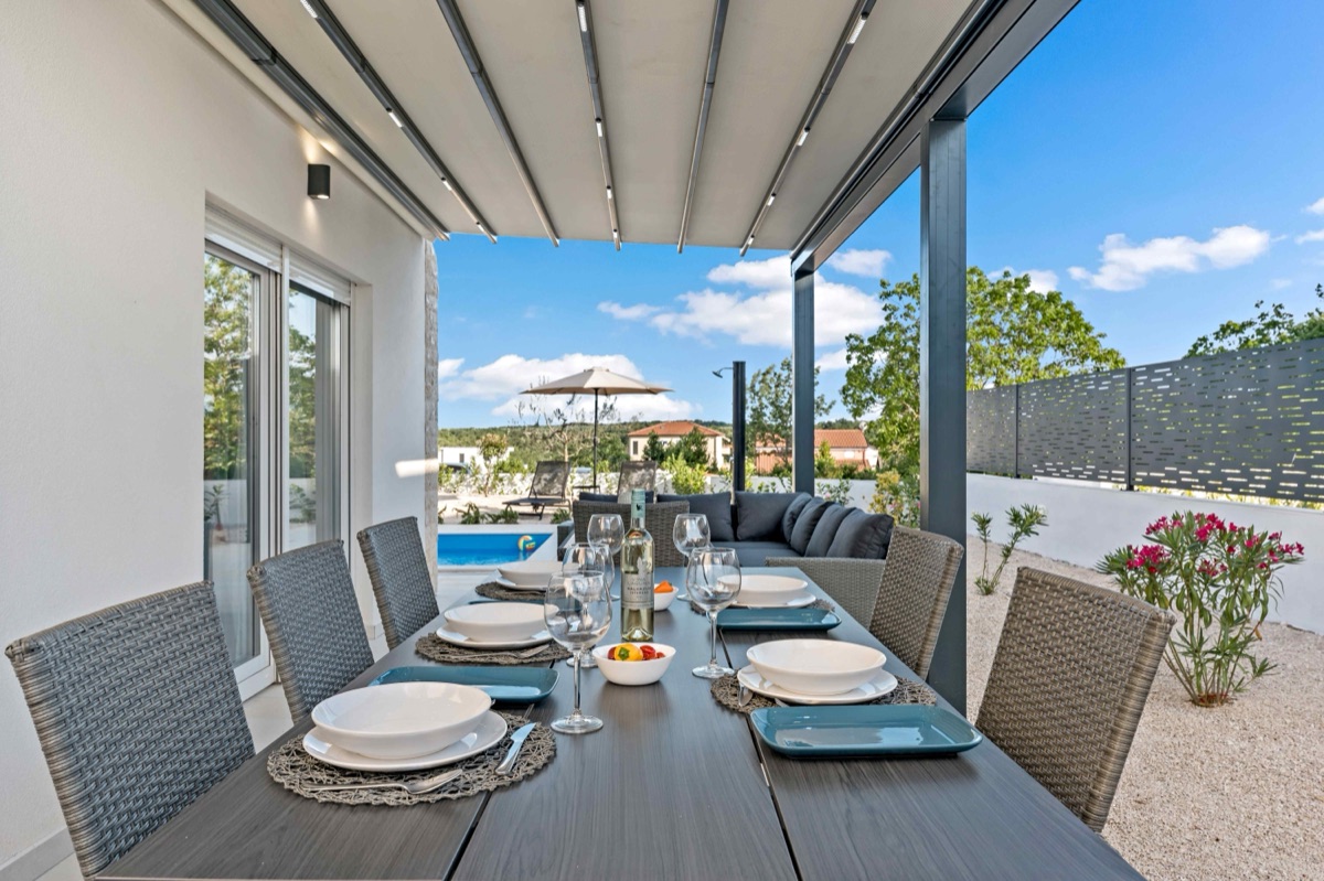 Outdoor dining with pool view