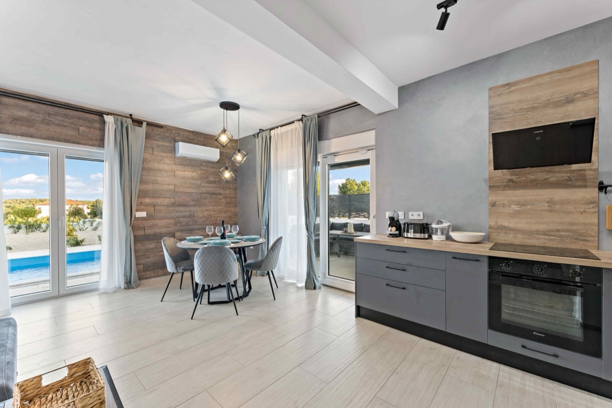 Kitchen and dining with pool view