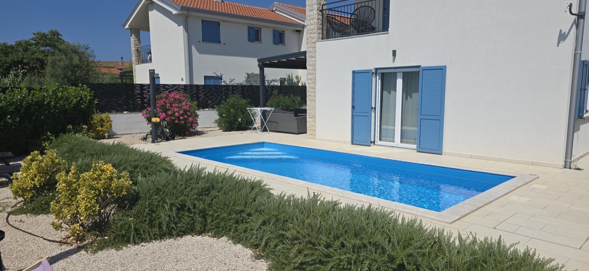 Pool with blue shutters and pergola